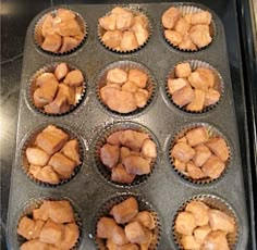 a muffin tin filled with cupcakes sitting on top of a stove