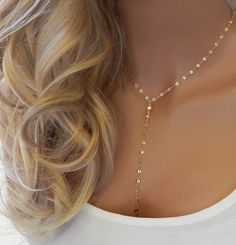 "GOLD LARIAT NECKLACE CHOKER This gold or silver drop necklace features dainty shiny discs that catch the light and is very sparkly. The model in photo #1 is wearing 17\" with the small disc chain. IT'S IN THE DETAILS ✦ 14K Gold Filled or Sterling Silver ✦ Chain Drops of 4\" and 5\" ✦ Large or small discs (See photo #4) ✦ Necklace is shown at 17\" in photo #3 For matching earrings, click here: https://www.etsy.com/listing/590775763 ✦ For Layered Lariat, as shown in photo #5, click here: https:// Luxury Dainty Lariat Necklace For Gift, Dainty Lariat Backdrop Necklace With Adjustable Chain, Adjustable Y-shape Lariat Necklace, Dainty Lariat Necklace With Adjustable Chain For Party, Delicate Lariat Necklace With Clavicle Chain, Clavicle Chain Y-shape Drop Necklace, Delicate Chain Lariat Layered Necklace, Clavicle Chain Drop Necklace In Y-shape, Delicate Layered Lariat Necklace With Clavicle Chain