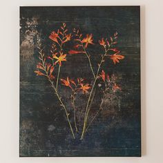 an abstract painting with orange flowers on a black background