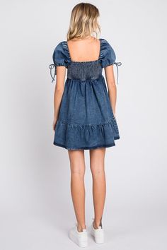 Gee Gee Our cheeky blue wash denim mini dress is so cute and trendy. Elastic shirred back, ruffle hem, seamed bodice details on sweetheart neckline. Short puffy sleeves with bow accents. Dark wash hem accented. Heavyweight denim for fall winter would go great with your boots! A must have! Color: Wash Denim Sizes: S-M-L Bust 34-36-38, Length 33-34 70% Cotton, 28% Polyester, 2% Spandex, hand wash cold, imported MD50509 Cotton Fitted Mini Dress With Smocked Back, Fitted Cotton Mini Dress With Smocked Back, Dark Wash Denim Mini Dress For Day Out, Denim Mini Dress With Frayed Hem, Fitted Cotton Mini Dress With Frayed Hem, Summer Denim Puff Sleeve Mini Dress, Summer Denim Mini Dress With Puff Sleeves, Denim Puff Sleeve Mini Dress For Summer, Medium Wash Mini Dress With Frayed Hem