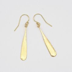 Pair of silver earrings shaped like elongated teardrop. Minimalist Teardrop Earrings For Party, Sleek Metal Drop Earrings, Modern Teardrop Earrings With Ear Wire For Formal Occasions, Modern Teardrop Earrings With Ear Wire For Formal Events, Minimalist Long Drop Teardrop Earrings For Formal Occasions, Sleek Earrings For Gift, Formal Minimalist Long Drop Teardrop Earrings, Modern Gold Teardrop Earrings For Evening, Minimalist Dangle Earrings For Evening