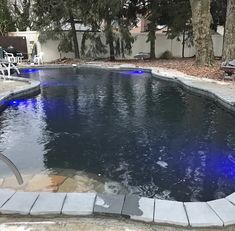 an outdoor swimming pool with blue lights