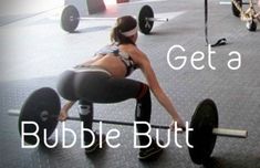 a woman squats on a barbell in a gym