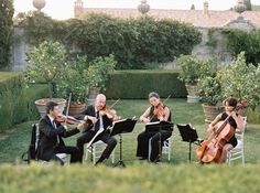 an orchestra playing in the garden with their instruments