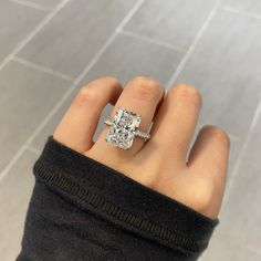 a woman's hand with a diamond ring on it