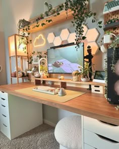 a desk with some plants on it and a television in the corner next to it