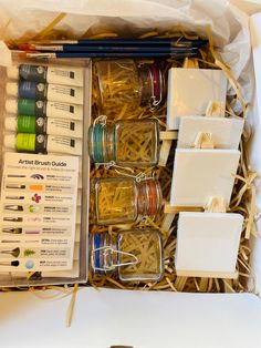 a box filled with lots of different types of crafting supplies next to each other