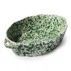 a green and white speckled bowl with handles