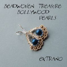 a pair of earrings with pearls and blue beads on the end of each bead