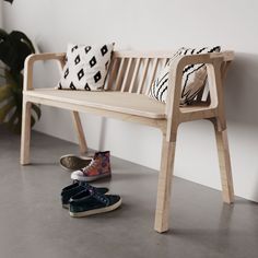 a pair of shoes sitting next to a wooden bench