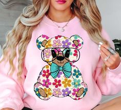 Colorful Daisy Teddy Bear Spring Sweatshirt | Unique Gifts for Family Friends   Embrace the spirit of spring with our vibrant color palette, featuring pastel hues and refreshing tones that capture the essence of nature's awakening. Whether you're strolling through blooming gardens or enjoying a picnic in the park, our crewnecks effortlessly elevate your spring wardrobe. Stay cool and comfy with our spring crewnecks.   Key Features: High-Quality Material: Made from soft and durable fabric, this sweatshirt is built to last and keep you cool and comfy. Unisex Design: This versatile pullover suits all genders, offering a relaxed and comfortable fit. Charming Appeal: Our spring sweatshirts are designed to add a touch of charm to your seasonal attire, making you stand out in style.   Physical At Spring Sweatshirt, Vibrant Color Palette, Picnic In The Park, Pastel Hues, Spring Wardrobe, A Picnic, Stay Cool, Unisex Design, The Park