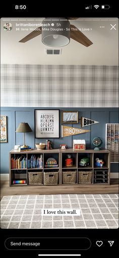 the room is decorated in blue and white with pictures on the wall, bookshelves and baskets