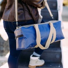 Travel in style with our stylish and spacious duffle bag! From upcycled Southwest Airlines leather our expert artisans handcraft each bag for maximum quality. Tan leather and Southwest's signature Canyon Blue complement one another, creating a chic travel bag. We know how hard it can be to fit everything you need into one bag when traveling. Here's to better packing! This bag is made from upcycled leather from Southwest Airlines seat covers which have been cleaned and refurbished prior to being Leather Duffle Bag With Removable Pouch For On-the-go, Leather Rectangular Duffle Bag, Versatile Leather Rectangular Duffle Bag, Versatile Rectangular Leather Duffle Bag, Versatile Everyday Leather Gym Bag, Versatile Leather Gym Bag For Everyday Use, Everyday Leather Gym Bag, Leather Duffle Bag With Removable Pouch For Everyday, Everyday Leather Duffle Bag With Removable Pouch