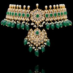 Indulge in the allure of this exquisite jewelry set and let contemporary grace redefine your fashion narrative! Radiate elegance and dangle in delight with our enchanting Esha Set – a mesmerizing blend of elegance and vibrancy meticulously crafted with sparkling zircons, complemented by the refreshing allure of emerald green stones, and embellished with delicately dangling green beads to elevate your style with the perfect harmony of sophistication and playfulness. The set includes a necklace, a maang teekah and a pair of trendy earrings. Approximate earrings length is 3.25". Gold-plated on high-quality brass as base metal. Made by order. Kindly allow 4-6 weeks for the delivery of this item. For custom or urgent requests, please contact support@alacouture.com. *Please Note: We use faux sto Elegant Bridal Sets With Crystal Stone Work, Diamond Gemstone Jewelry For Reception, Reception Diamond Gemstone Jewelry, Elegant Chandbali Jewelry With Stone Work, Elegant Chandbali Stone Work Jewelry, Elegant Kundan Hand Set, Dazzling Jewelry Sets For Reception, Luxury Diamond Jewelry Sets For Festive Season, Exquisite Cubic Zirconia Jewelry For Festive Season