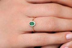 "Emerald Ring / 14k Classic Oval Cut Emerald Ring with Surrounding Diamonds / Natural Emerald Ring in 14k Solid Gold / Mothers Day Gift * If you would like to see the Matching Earrings Please Click Below https://www.etsy.com/listing/604292239/emerald-earrings-14k-oval-cut-emerald?ref=related-4 * If you would like to see the Matching Necklace Please click Below https://www.etsy.com/listing/590436480/emerald-necklace-14k-classic-oval-cut?ref=related-1 Item Features * Made to Order. * Gold KT: 14K Dainty Oval Diamond Ring For Anniversary, Dainty Oval Diamond Anniversary Ring, 14k Yellow Gold Cluster Ring With Oval Shape, Oval Yellow Gold Emerald Ring With Halo, Dainty Oval Halo Rings, Yellow Gold Oval Halo Rings, Oval Stamped 14k Halo Ring Fine Jewelry, Oval Halo Ring Stamped 14k Fine Jewelry, Dainty Oval Diamond Ring In 14k Gold