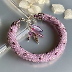 Bright  purple crystal beads bracelet, Crochet beaded bracelet, Bright colors bracelet  This tender bracelet elegantly sneaks on knits and silks, on coats and skimpy dresses, whenever and wherever she wants. As long as it is close to us in our sweetest adventures, colored in cotton candy and fabulous pastels  〰️〰️〰️〰️〰️〰️〰️ ✔️Bracelet  made of Japanese crystal beads and silver fittings. ✔️The colors are sweet , mesmerizing, luxurious, but at the same time quite unpretentious. * ORIGINAL DESIGN Elegant Lavender Beaded Bracelets, Elegant Handmade Lavender Crystal Bracelet, Elegant Hand Wrapped Crystal Bangle Bracelet, Handmade Pink Crystal Elegant Bracelet, Elegant Beaded Lavender Bracelets, Handmade Pink Crystal Bracelet For Wedding, Handmade Elegant Pink Crystal Bracelet, Handmade Crystal Wedding Bracelet, Elegant Handmade Pink Crystal Bracelet