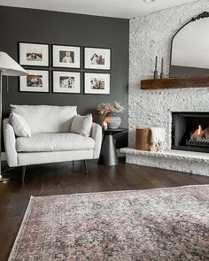 a living room filled with furniture and a fire place