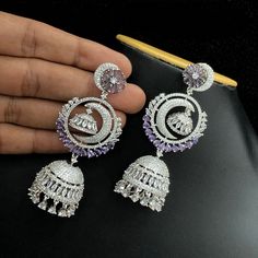 These Silver Polish American Diamond Long Chandbali Jhumka Earrings are perfect for a special occasion. With an intricately detailed crescent moon dangle and radiant American diamond, they shine as exquisitely as they look. Ideal for traditional Indian weddings, these earrings will make an iconic statement. Length of the Earrings 3.25 Inches Luxury Hand Set Chandbalis Drop Earrings, Luxury White Chandbalis For Women, Luxury Silver Chandbalis With Hand Set Details, Luxury Silver Chandbalis For Celebration, Luxury Silver Chandbalis For Festivals, Elegant Luxury Chandbalis For Eid, Luxury Traditional American Diamond Danglers, Luxury Traditional White Chandbalis, Luxury Sterling Silver Chandbali Danglers