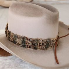 The Moab Western Feather Hat Band features a width of 3 cm and an approximate length of 58 cm, not including the leather ties. This adjustable hat band fits most sizes, with leather ties ensuring a secure and customizable fit. Its feather detailing adds a touch of western sophistication, making it a stylish enhancement for any hat. Cowgirl Hat Bands, Feather Hat Band, Hat Bands, Feather Hat, Band Fits, Cowgirl Hat, Pets For Sale, Cowboy Boots Women, Cuff Rings