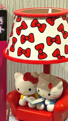 a hello kitty lamp sitting on top of a red chair