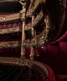 an ornately decorated auditorium with red seats