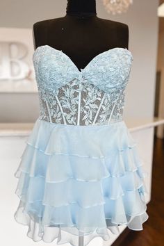 Strapless Light Blue Applique Beaded Ruffle Homecoming Dress Light Blue Ruffled Dresses For Prom, Light Blue Ruffled Dresses For Prom Season, Blue Ruffled Corset Dress For Wedding, Blue Ruffled Mini Dress For Homecoming, Blue Strapless Ruffle Dress For Prom, Blue Strapless Ruffled Dress For Prom, Light Blue Sweetheart Neckline Dress With Ruffles, Elegant Blue Strapless Dress With Ruffles, Blue Strapless Dress With Ruffles For Prom