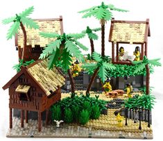 a lego model of a tropical island with palm trees and people sitting on the beach