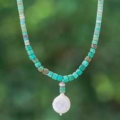 Mystic as the sea, this beaded necklace combines ethereal colors for a stylish look. Thailand's Somluck Komolmith uses reconstituted turquoise jewels to create this bohemian necklace, accented with a cultured pearl pendant in a natural white tone—like a moon over the ocean. The accessory has a sterling silver clasp and extender. Bohemian Turquoise Pearl Necklace With Colorful Beads, Bohemian Beaded Turquoise Pearl Necklace, Adjustable Bohemian Turquoise Pearl Necklace, Bohemian Turquoise Beaded Pearl Necklace, Bohemian Pearl Necklace With Gemstone Beads, Bohemian Pearl Necklace With Polished Beads, Bohemian Turquoise Pearl Necklace With Gemstone Beads, Moon Over The Ocean, Ethereal Colors