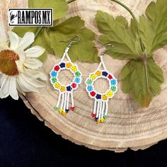 Beautiful Handmade Mexican Earrings , Mexican Shakira Earrings , Bohemian Boho earrings. 100% Handmade Handcraft by great Artisans in Mexico , These lovely Ear Wire earrings are extremely light and can be worn on all everyday occasions specially if you like colorful and fresh accessories. Aprox Size : 3 1/4 inches length & 1 3/8 inch wide Every piece is unique and color might change a little , depending on the screen device its been viewed on Aretes Mexicanos de Shakira , hecho a mano , Arte for Bohemian Multicolor Hoop Earrings With Dangling Beads, White Bohemian Hoop Earrings With Colorful Beads, White Bohemian Dangle Hoop Earrings, Bohemian Rainbow Earrings With Dangling Beads, Festival Colorful Beaded White Hoop Earrings, Multicolor Dangle Earrings With Beads, Festival White Hoop Earrings With Colorful Beads, Multicolor Drop Earrings With Dangling Beads, Multicolor Flower Drop Earrings With Dangling Beads