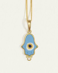 Turquoise blue ceramic hamsa necklace with evil eye. Protective talisman in 22k solid gold & diamond. Shop amulet hand pendant handcrafted in Istanbul. Symbolic Blue Gemstone Necklaces, Blue Gemstone Symbolic Necklace, Symbolic Blue Gemstone Necklace, Traditional Blue Evil Eye Jewelry, Sun Amulet, Hand Pendant, Gemstone Properties, Hamsa Necklace, Amulet Necklace