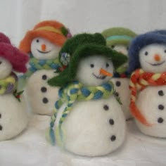 six snowmen with hats and scarves on their heads