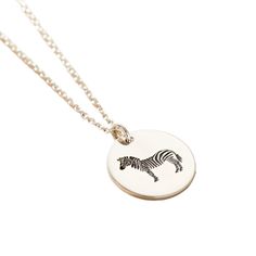 This unique Zebra Spirit Animal Necklace is made in our Brighton workshop. Crafted from 925 sterling silver the pendant is engraved with an intricate Zebra design. Zebra’s are are unique, bold, beautiful, quick witted, resourceful, and adaptable. The disc is suspended from a fine trace chain necklace. This necklace makes the perfect birthday gift for someone special. The necklace is handmade in sterling silver. Pendant measures 1. 6mm across. Comes suspended on 18" fine chain. Handmade in 925 Sterling Silver Posh Totty, Zebra Design, Animal Necklace, Perfect Birthday Gift, Pet Necklace, African Safari, Safari Animals, Watch Necklace, Perfect Birthday