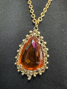 Vintage gold tone orange 5cm amber faceted Glass teardrop pendant necklace on 70cm chain Metal Dangle Jewelry For Collectors, Antique Amber Pendant Necklaces, Antique Amber Necklace With Gemstone, Elegant Collectible Glass Jewelry, Antique Amber Gemstone Necklace, Antique Amber Pendant Necklace, Elegant Glass Drop Jewelry, Elegant Drop Glass Jewelry, Unique Glass Jewelry For Formal Occasions