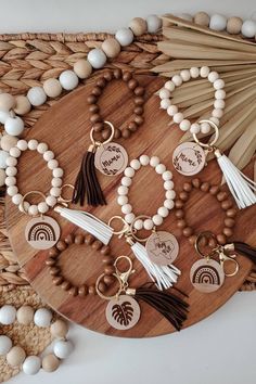 wooden beads and tassels are arranged on a table with an assortment of keychains