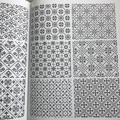 an open book with black and white cross stitchs on the pages, in which there is