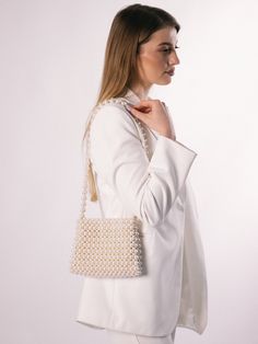 An ivory beaded bag is a versatile accessory that can be dressed up or down, making it suitable for a range of occasions, such as weddings, cocktail parties, or formal events. It can add a touch of elegance and sophistication to any outfit. The bag is roomy, fits a phone 15 cm long and many women's things. The bag is woven from fishing  line, which can withstand 25 kg. It is very reliable as it closes with a magnetic clasp. 100% handmade Material: acrylic pearl beads 8 mm & 12 mm Size:  > width Formal Pearl White Evening Bag, Elegant Pouch Clutch With Pearl Handle, Pearl Beaded Evening Bag For Formal Occasions, Formal Beaded Pearl Evening Bag, Elegant Pearl Bags For Formal Occasions, Pearl Handle Shoulder Evening Bag As Gift, Feminine Evening Bag With Pearl Handle For Formal Occasions, Feminine Evening Bag With Pearl Handle For Formal Events, Beige Clutch With Pearl Handle For Event