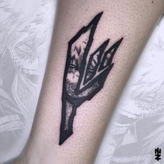 a close up of a person's arm with an arrow tattoo on the leg