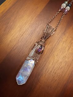 This unique wire wrap is made from an Aura Quartz Point wrapped in antiqued copper wire. It has a faceted amethyst worked into the front of the piece and comes on a matching 20 inch copper chain. Amethyst: relaxing energy, third eye, balances the mind, intuitive solutions to problems, may help with addiction Luxury Statement Wire Wrapped Jewelry, Luxury Wire Wrapped Pendant Jewelry, Wire Wrapped Crystal Point, Wire Wrapping Crystal Points, Wrapping Crystals, Wire Crystal, Wire Wrapped Stone Jewelry, Wire Wrap Jewelry Designs, Moonstone Pendant Necklace