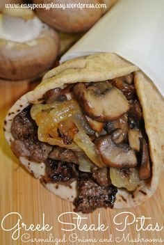 a close up of a burrito on a cutting board with mushrooms and onions in it