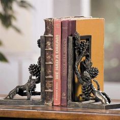 Functional and beautiful, these pinecone motif bookends will hold your books and adorn your shelves with a warm and rustic style. Made of cast aluminum with antique brown patina.  Dimensions:Ã‚ 8"H 5.5"W 3.5"D Weight:Ã‚ 7.00lbs Black Forest Decor, Decorative Bookends, Iron Accents, Rustic Cabin Decor, Pine Branch, Cabin Style, Rustic Cabin, Cabins In The Woods, Cabin Decor