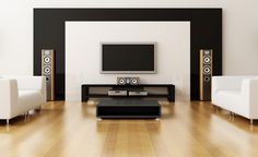 a living room filled with white furniture and a flat screen tv mounted on the wall