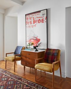 two chairs sitting next to each other on top of a hard wood floored floor