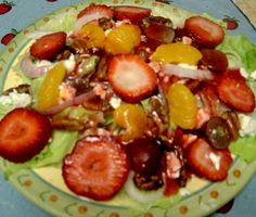 a salad with strawberries and other fruits on it