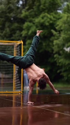 a man doing a handstand in the rain