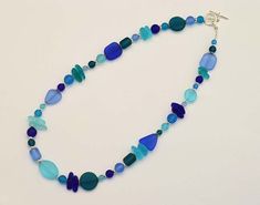 "I made this blue sea glass necklace with high-quality frosted glass that resembles ocean tumbled sea glass, but comes at a fraction of the price. Therefore, the beach glass is consistent in shapes and sizes, so your necklace will look like the one in the photos. Please note that the shape and order of the sea glass beads may vary (depending availability), but the overall look will remain the same. The beach glass necklace is light, but very sturdy. I make these sea glass necklaces to be 16\"-22 Blue Sea Glass Jewelry Gift, Blue Sea Glass Jewelry As A Gift, Handmade Blue Sea Glass Jewelry, Handmade Blue Jewelry With Sea Glass, Blue Recycled Glass Jewelry As Gift, Blue Recycled Glass Jewelry For Gift, Ocean-inspired Blue Sea Glass Necklaces, Blue Sea Glass Necklaces For Jewelry Making, Nickel-free Blue Sea Glass Jewelry