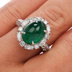 This exquisite GIA Natural Emerald & Diamond Cocktail Ring is expertly crafted in solid platinum with a total weight of 9.54 grams. The emerald with a weight of approx. 5.17 carats are surrounded by (6) round cut and (6) marquise cut genuine natural diamonds, (12) round-cut genuine natural diamonds placed on either side of the ring. All G-H color, and VS clarity forming a dazzling oval halo, The top of this piece measures 17 mm x 22 mm, 10 mm (height) currently US ring size 4.75 and sizable. Exquisite Oval Platinum Gemstones, Luxury Oval Emerald Birthstone Ring, Luxury Oval Emerald Gemstones, Luxury Oval Platinum Gemstones, Oval Brilliant Cut Emerald Gemstones, Gia Certified Oval Emerald Gemstone, Oval Emerald Gemstone With Center Stone, Gia Certified Oval Emerald, Luxury White Gold Oval Cabochon Emerald Ring