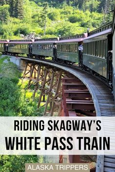 a train traveling over a bridge with trees in the background and text reading riding skagway's white pass train