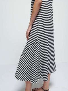 It's your essential t-shirt dress, now with subtle seamed pleats on the front for an effortlessly feminine silhouette. Perfect for moving from off-duty to on-duty with nothing more than a chic belt around the waist. (This one comes in City Stripe.) | Eileen Dress in City Stripe | Ethical Essentials Casual Midi Dress With Relaxed Skirt, Casual Dresses With Relaxed Skirt For Work, Casual Dress With Relaxed Skirt For Work, Effortless Summer Dresses For Everyday, Casual Dress With Relaxed Skirt For Daywear, Chic Belt, Striped T Shirt Dress, Stripe T Shirt, Feminine Silhouette