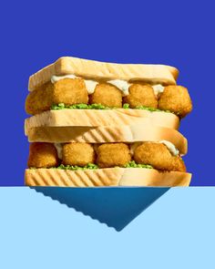 two sandwiches stacked on top of each other with chicken nuggets in between them