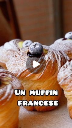 some croissants with blueberries on them and the words un muffin francese